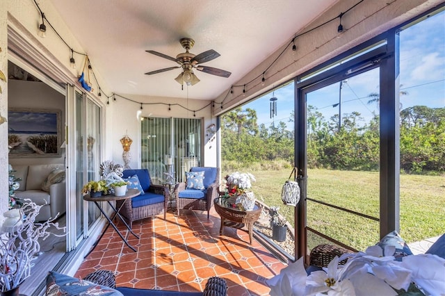 sunroom featuring ceiling fan