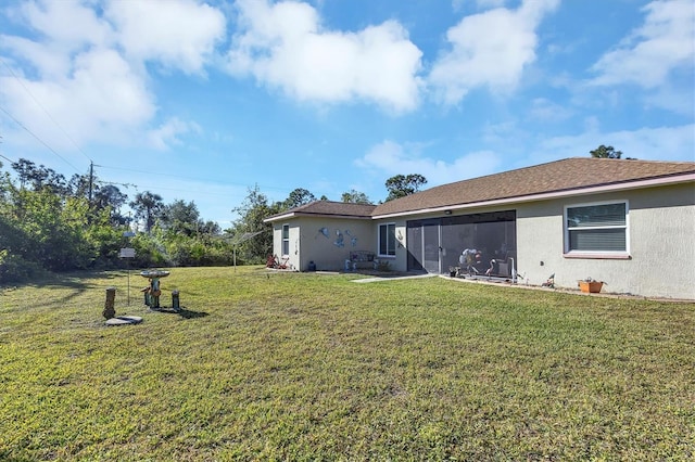 rear view of property with a lawn