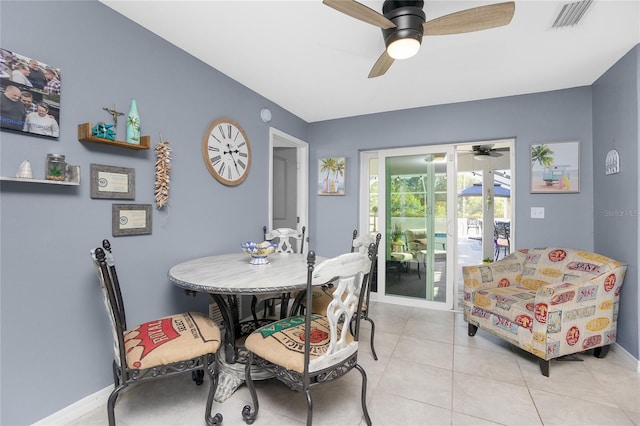 tiled dining area featuring ceiling fan