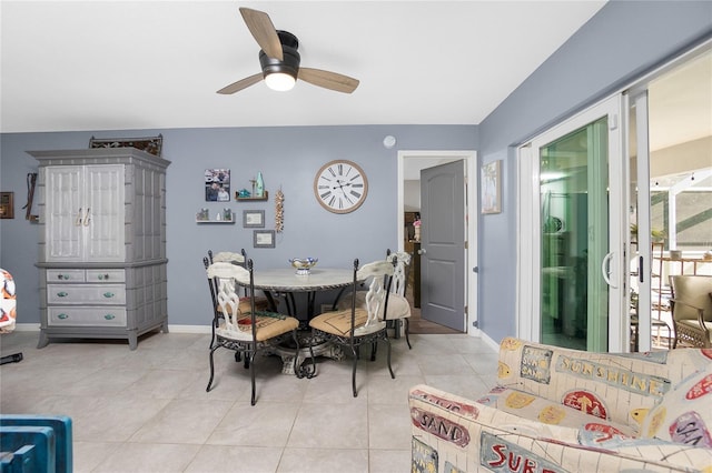 tiled dining room featuring ceiling fan