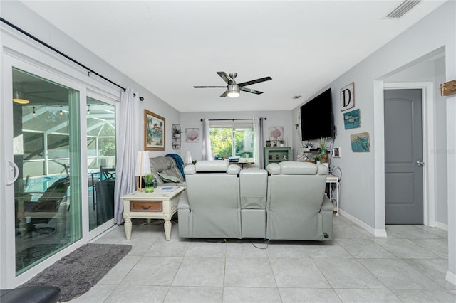 tiled living room featuring ceiling fan