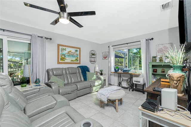 living room with light tile patterned flooring and ceiling fan