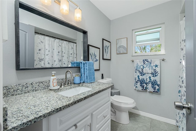 bathroom featuring tile patterned flooring, vanity, and toilet