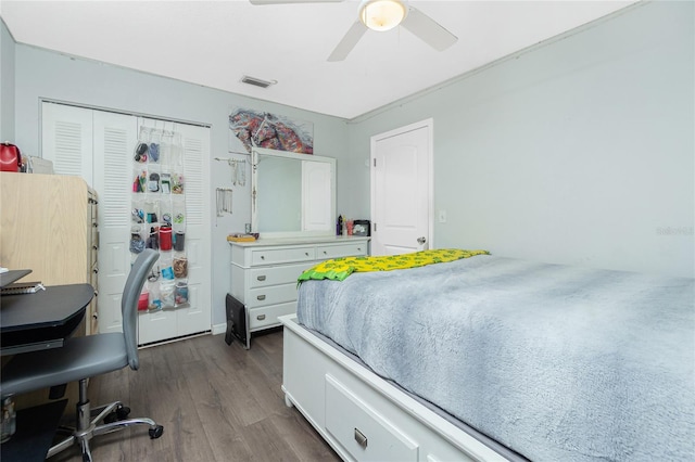 bedroom with dark wood-type flooring, a closet, and ceiling fan