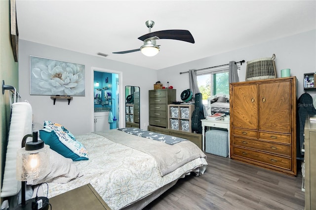 bedroom featuring connected bathroom, hardwood / wood-style floors, and ceiling fan