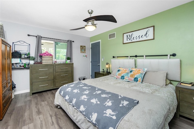 bedroom with light hardwood / wood-style floors and ceiling fan