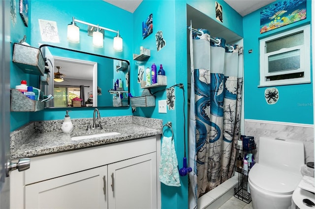 bathroom featuring vanity, ceiling fan, a shower with curtain, and toilet