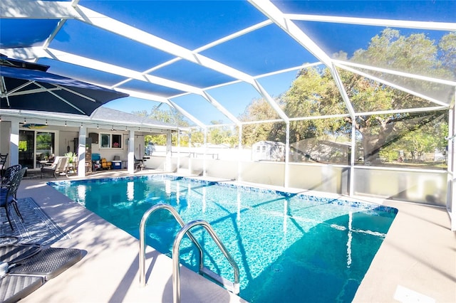 view of swimming pool with a lanai and a patio area