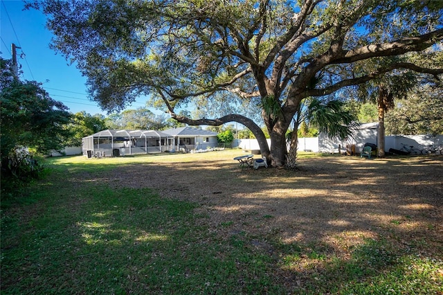 view of yard featuring glass enclosure