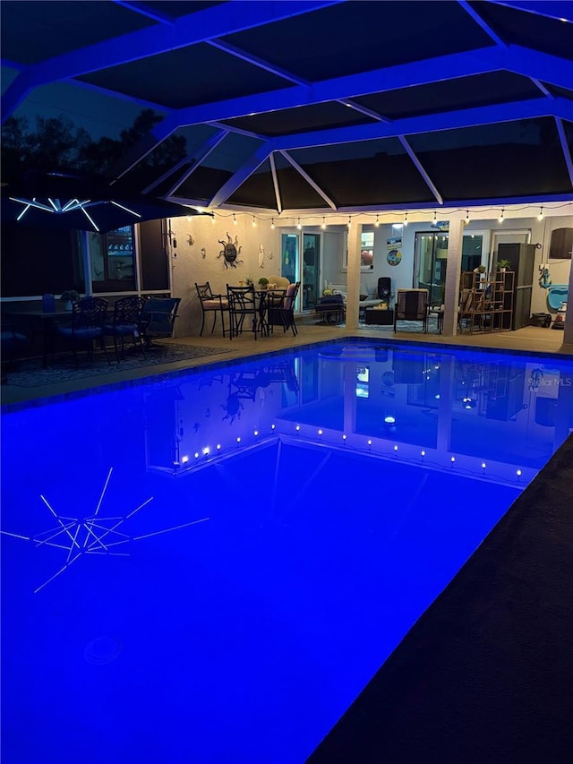 view of swimming pool featuring a lanai and a patio area