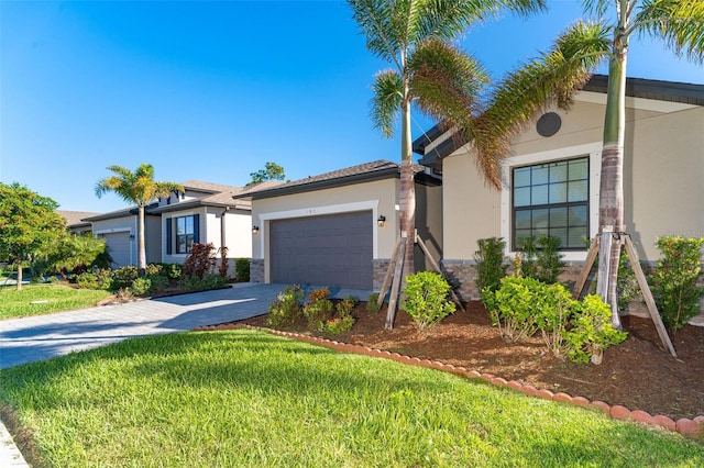 view of front of home with a garage and a front lawn