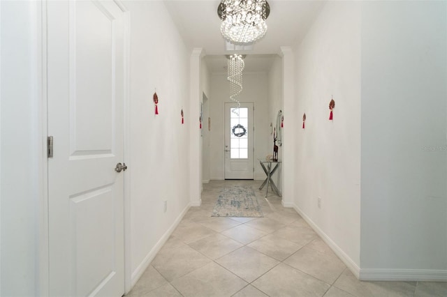 entryway featuring light tile patterned flooring and a chandelier