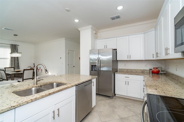 kitchen featuring white cabinets, stainless steel appliances, ornamental molding, and sink