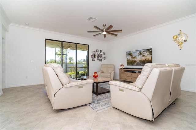 tiled living room with ceiling fan and crown molding