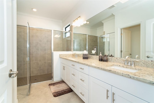 bathroom featuring tile patterned flooring, vanity, crown molding, and a shower with shower door