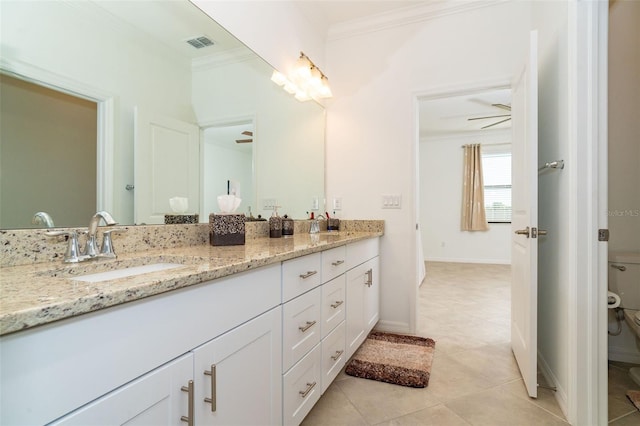 bathroom with ceiling fan, tile patterned flooring, toilet, vanity, and ornamental molding