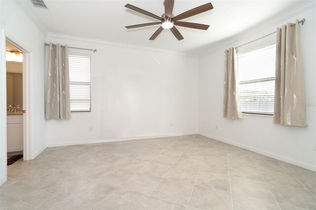 spare room featuring light tile patterned floors, ceiling fan, and ornamental molding