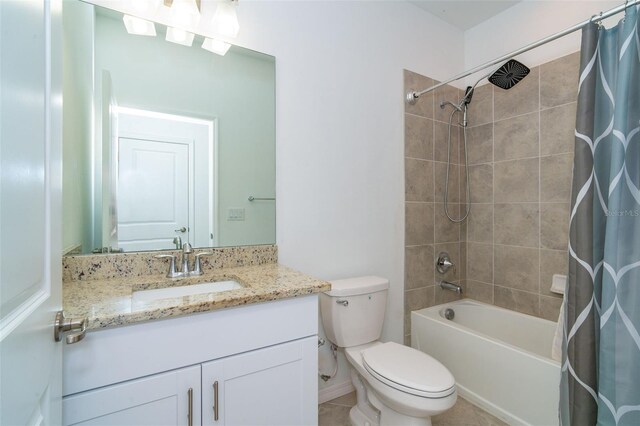 full bathroom with tile patterned flooring, shower / tub combo, vanity, and toilet