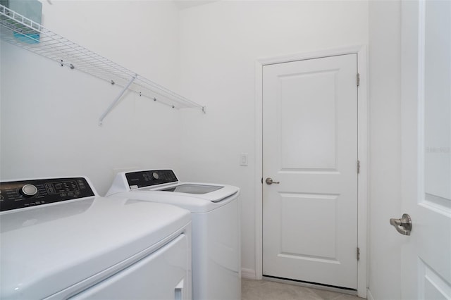 19584 Fishhawk Trl, Venice, FL 34293 - washroom with washing machine and clothes dryer and light tile patterned floors