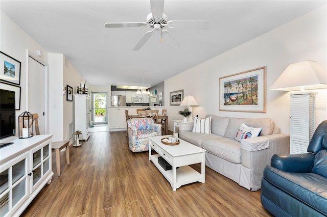 living room with ceiling fan and wood-type flooring