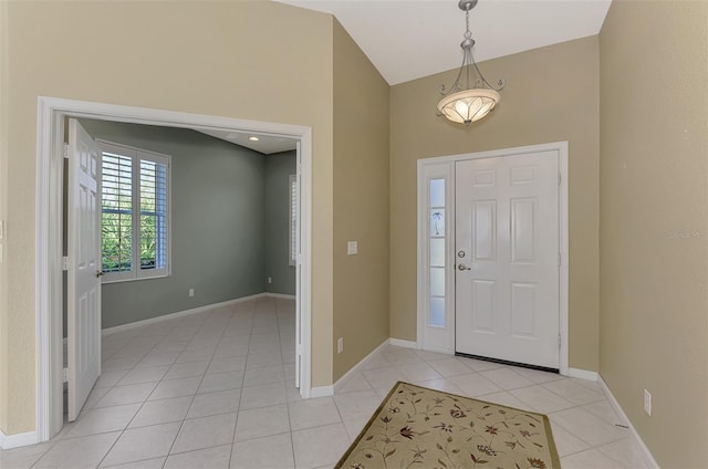 tiled foyer with vaulted ceiling