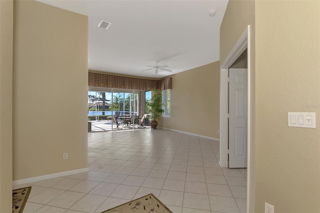 corridor featuring light tile patterned floors