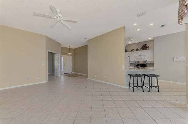 unfurnished living room with ceiling fan and light tile patterned floors