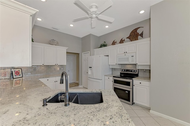 kitchen featuring white cabinetry, sink, and white appliances