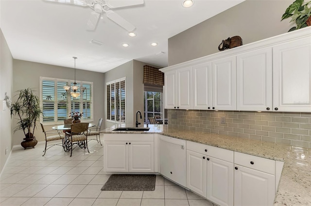 kitchen with white cabinetry, dishwasher, hanging light fixtures, and sink