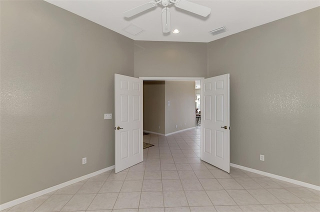 spare room featuring ceiling fan and light tile patterned floors