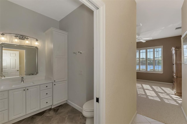 bathroom with tile patterned floors, vanity, toilet, and ceiling fan