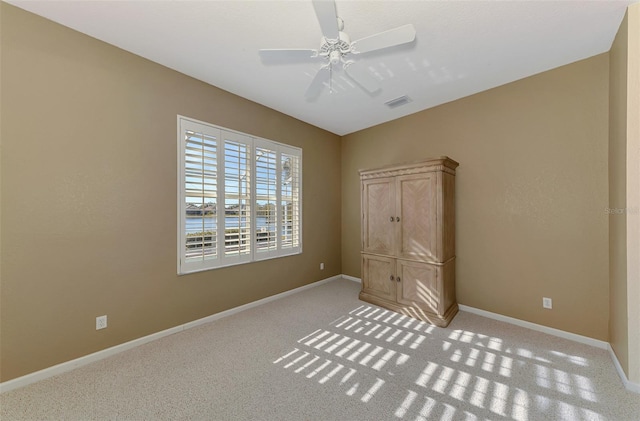 unfurnished bedroom with ceiling fan and light carpet