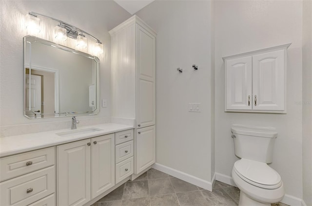 bathroom with tile patterned flooring, vanity, and toilet