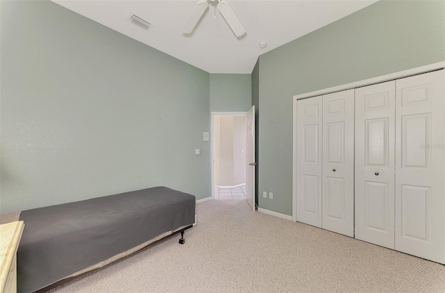 carpeted bedroom featuring a closet and ceiling fan