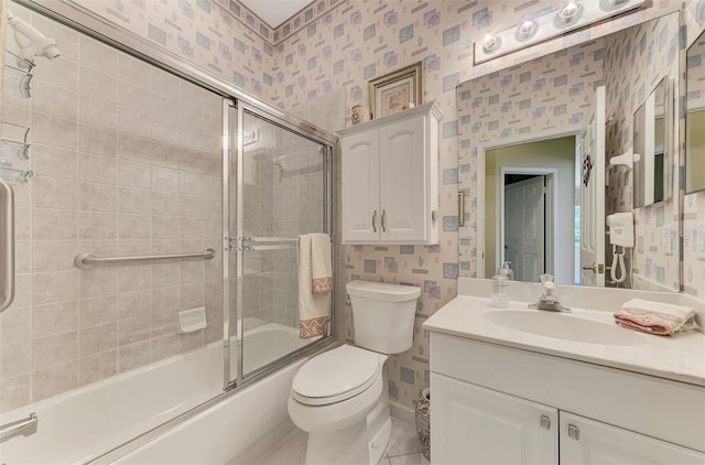 full bathroom featuring vanity, bath / shower combo with glass door, and toilet