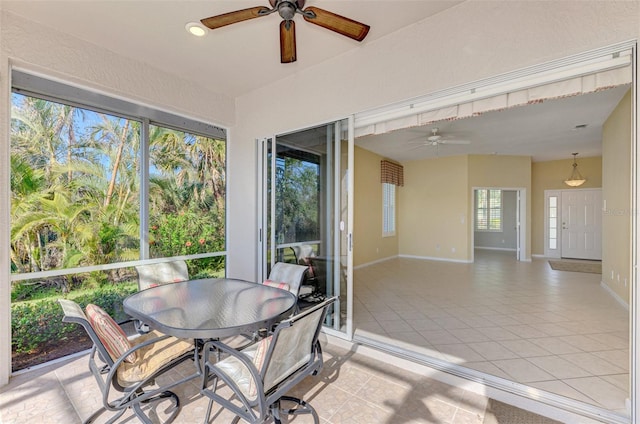 sunroom / solarium featuring ceiling fan