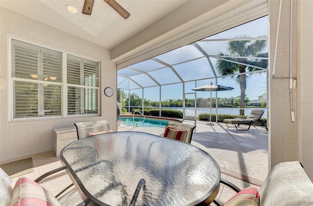 view of patio / terrace with a lanai and a water view