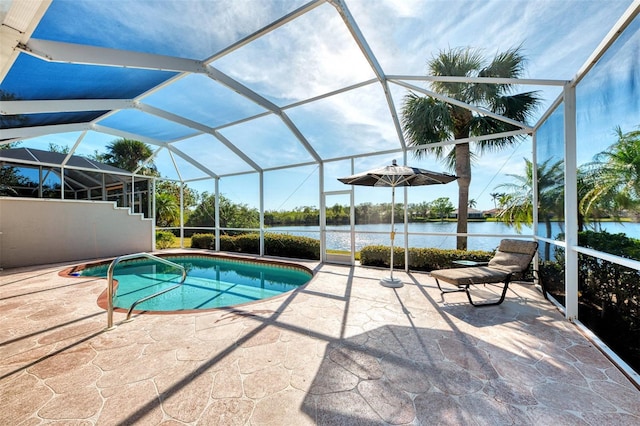 view of swimming pool featuring a patio, a water view, and glass enclosure