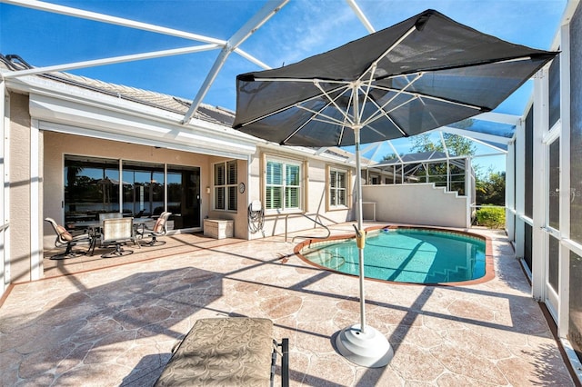 view of pool featuring a patio and glass enclosure