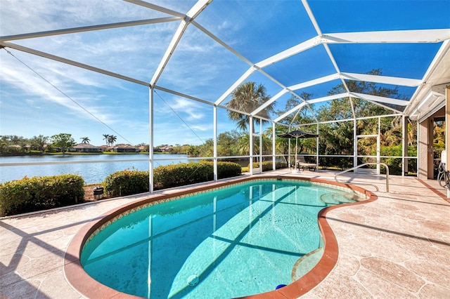 view of swimming pool with a patio, a water view, and glass enclosure