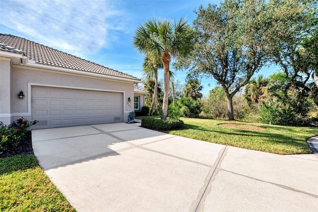 view of front of home with a front yard and a garage