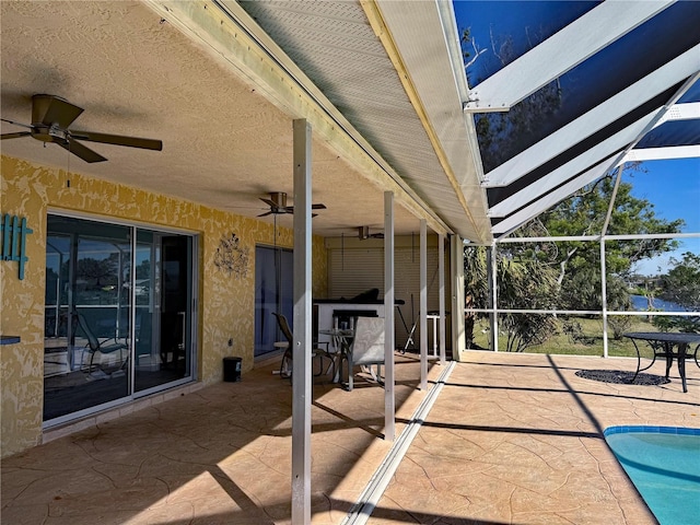 view of patio / terrace with glass enclosure and ceiling fan