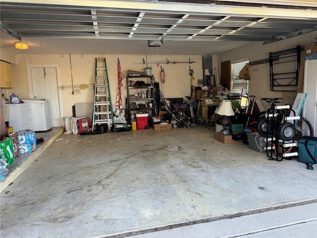 garage with a garage door opener and washing machine and clothes dryer