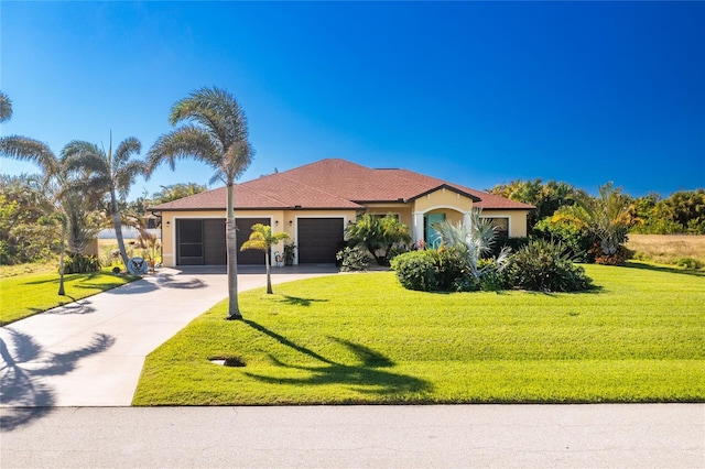 view of front of home featuring a front lawn and a garage