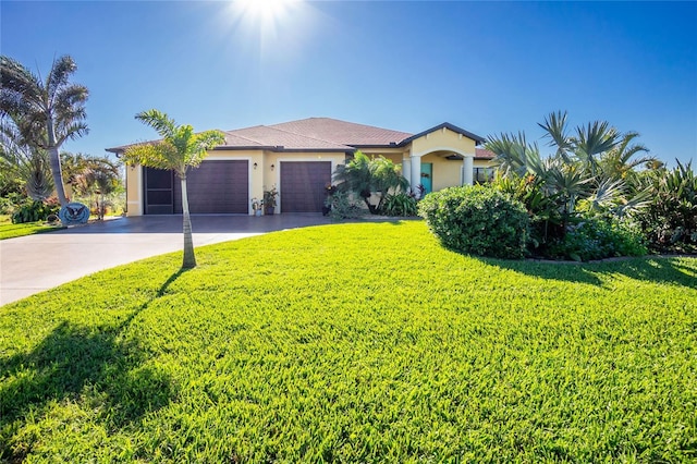 view of front facade with a front yard and a garage