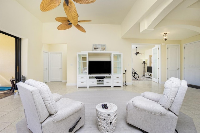 tiled living room with ceiling fan