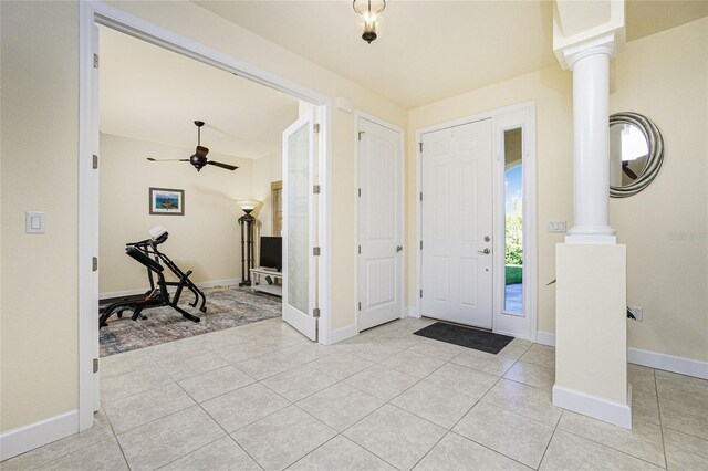 entryway with light tile patterned floors, ornate columns, and ceiling fan