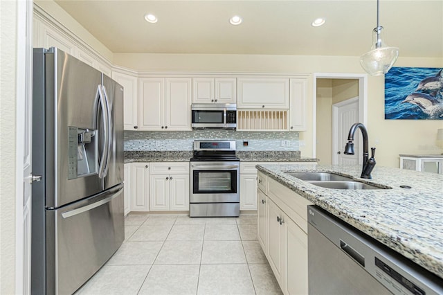 kitchen with white cabinets, light stone countertops, sink, and appliances with stainless steel finishes