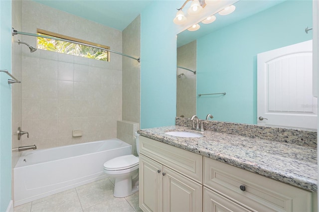 full bathroom with tile patterned flooring, vanity, toilet, and tiled shower / bath