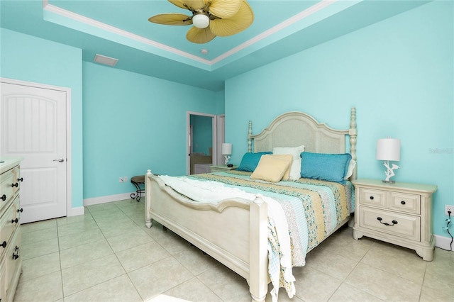 bedroom featuring ceiling fan, a raised ceiling, light tile patterned floors, and crown molding